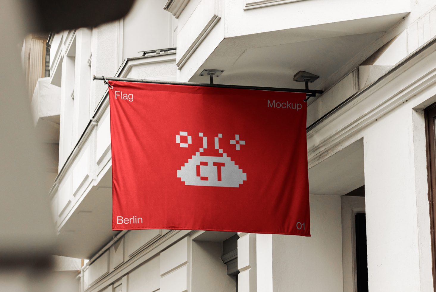 Red flag mockup with pixel-style logo design hanging on building exterior, urban setting, realistic display for branding. Graphic asset for designers.